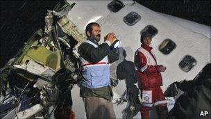 Rescue workers attend the scene after an IranAir Boeing 727 passenger plane crashed outside the city of Orumiyeh, northwest of the capital, Tehran, Iran, Jan. 9, 2011.