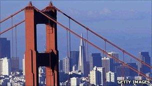 The skyline of San Francisco viewed through the cables of the Golden Gate Bridge
