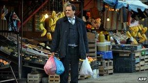 A man holds plastic bags in Quba market in Algiers, on January 10, 2011.