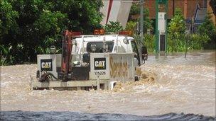 Truck driving through flood waters in Brisbane. Photo: Liam Hanlon