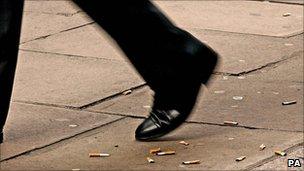 Man walking over cigarette ends