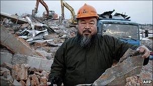 Chinese artist Ai Weiwei holds a piece of debris of his newly-built Shanghai studio after it was demolished