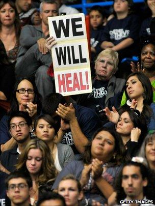 People listen to Barack Obama speaking at the McKale Memorial Center in Tucson (12 January 2011)