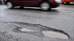 Car passing pothole