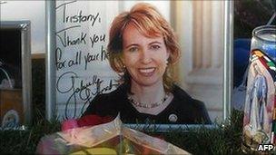 An autographed portrait of Congresswoman Gabrielle Giffords at a makeshift memorial outside the hospital in Tucson