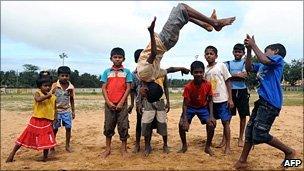 Sri Lankan flood-affected children play for the camera at a relief camp in the eastern Sri Lankan town of Batticaloa on 14 January 2011