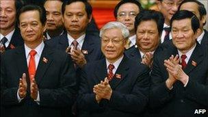 Sec General Nguyen Phu Trong (C), 66, poses with re-elected Politburo member and Prime Minister Nguyen Tan Dung (L) and re-elected Politburo member Truong Tan Sang (R) 19 Jan 2011