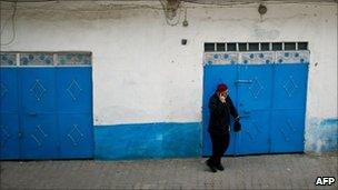 A man talks on the phone in a street of the Medina in Tunis