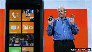 Steve Ballmer holds a Windows Phone 7 handset