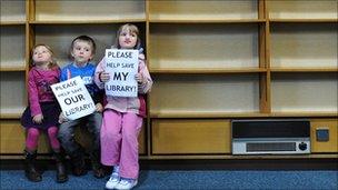 Children with empty library shelves as part of a campaign in Stony Stratford Library, Milton Keynes