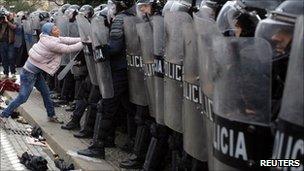 A protester defies riot police in Tirana, 21 January