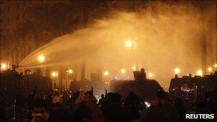 Riot police use water cannons to disperse anti-government demonstrators in downtown Cairo