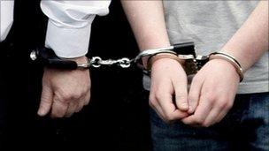 A young man in handcuffs