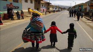 People from the Andean community of Ocongate district in the highlands of Cusco walk along the Interoceanic highway section linking Peru and Brazil in the Andean region of Cusco August 19, 2010