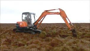 Digger machine on peat bog