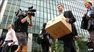 A Lehman Brothers worker removes his belongings after the firm folded in autumn 2008