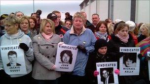 Bloody Sunday victims' relatives hold photographs of the dead