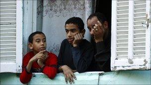 Cairo residents looking out of a window