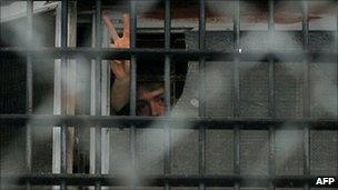 A man gestures from a window at a prison in Minsk, 23/12