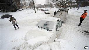A car stuck in a snowbank is towed away in Hartford, Connecticut - 1 February 2011