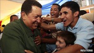 Venezuelan President Hugo Chavez greeting school children in a classroom on the 12th anniversary as president