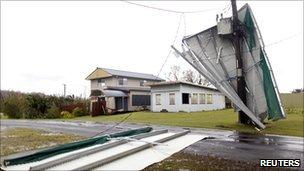 Debris wrapped around a telephone pole in Cowley Beach, Queensland, on 3 Feb 2011