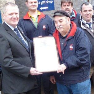 Brian Jeffrey receives an award marking 50 years' service