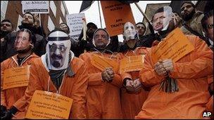 Islamic supporters wearing face masks of Arab countries leaders demonstrate in London