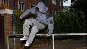 Teenager jumping over barrier