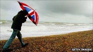 Man walking with Union flag umbrella