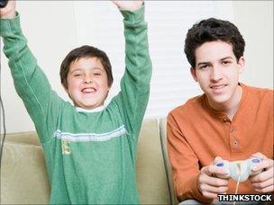 Boy and babysitter play computer games (Posed by model)