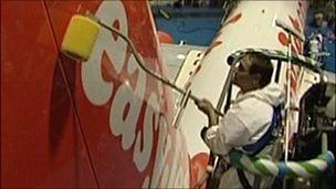 Man applying new coating to Easyjet plane