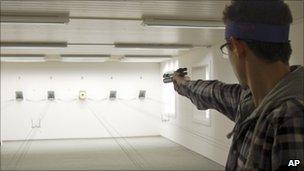 A man fires a pistol at a shooting range near Bern, Switzerland - 6 January 2011