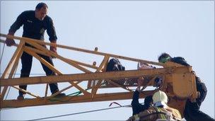 Activist being pulled off the crane