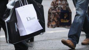 Dior shopping bag being carried