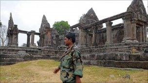 A Cambodian soldier walks past the Preah Vihear temple