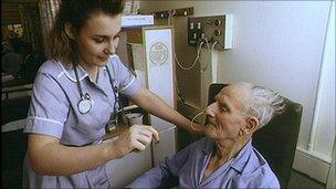 a nurse attending to an elderly patient