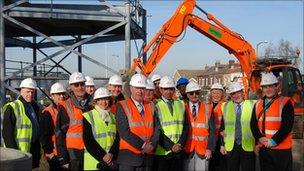 Representatives from organisations involved in the new youth centre view the start of the work