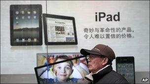 Man walks past iPad advert