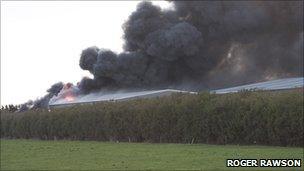 Smoke billowing from factory on fire