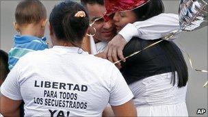 Former hostage Marcos Baquero, centre top, embraces his wife Olga Lucia Tao, right, after he was released by the Revolutionary Armed Forces of Colombia, Farc, in Villavicencio, Colombia, 9 February 2011