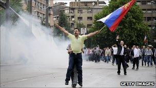 A man waves a Serbian flag during a protest in the divided town of Mitrovica (May 2010)