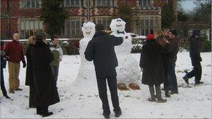 Guests model the bride and groom in the snow