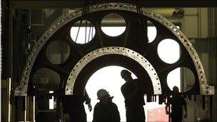 men examining a turbine