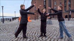 Jamie, Adam and Michael practise dancing together