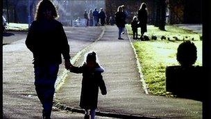 Mother holding daughter's hand