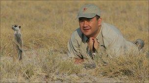 Jose Cortes looking at a meerkat