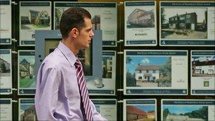 Man passes estate agent's window
