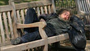 Man sleeping on a park bench