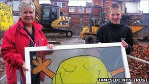 Linda Axon and Jack Shepherd hold the Mr Happy window